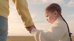 image of child holding a grown person's hand