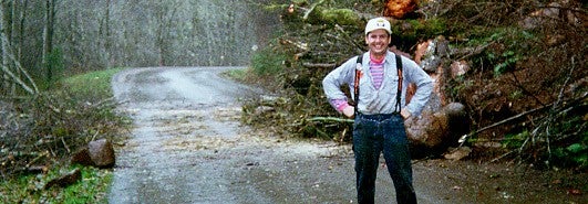 Person standing in front of forest road 