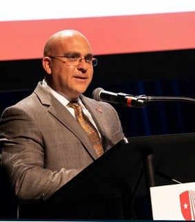 Lawrence Zacarese speaking at podium