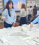 Two students work on architectural model together