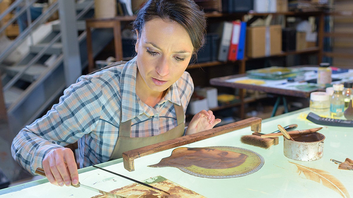 Woman analyzing artwork