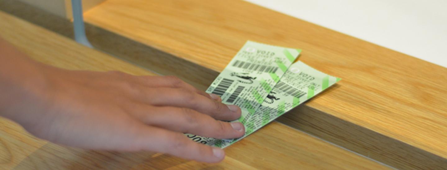 Customer receiving tickets to event from Ticket Office.