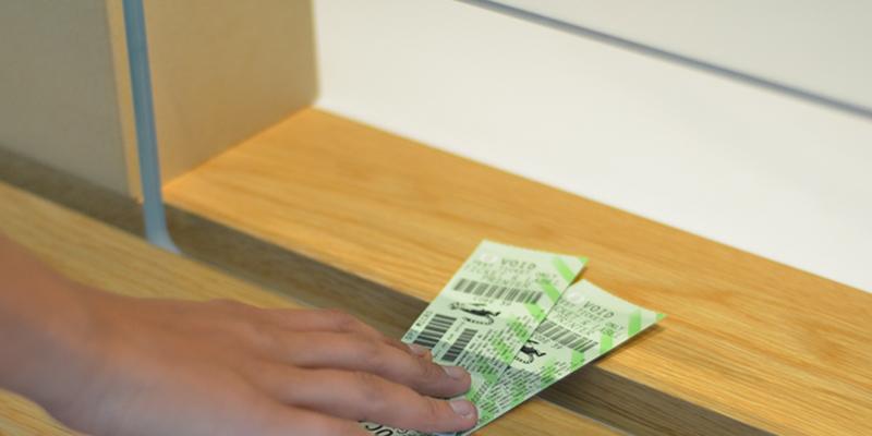 Customer receiving tickets to event from Ticket Office.