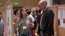 Student presenter presents her research project in EMU Ballroom
