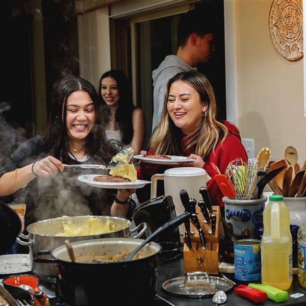 fig students sharing a meal together and smiling
