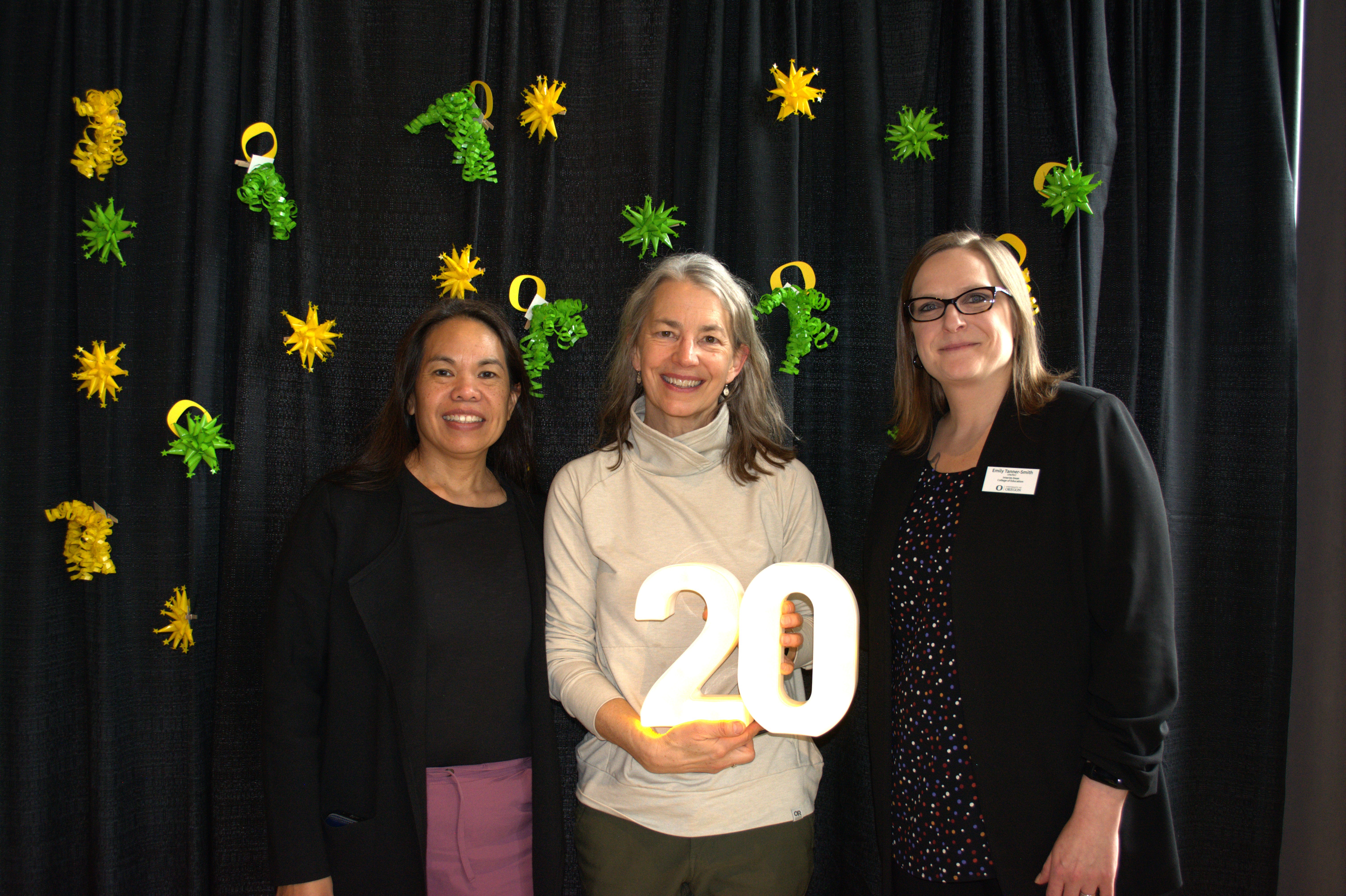 Three people celebrating someone's 20 years of service