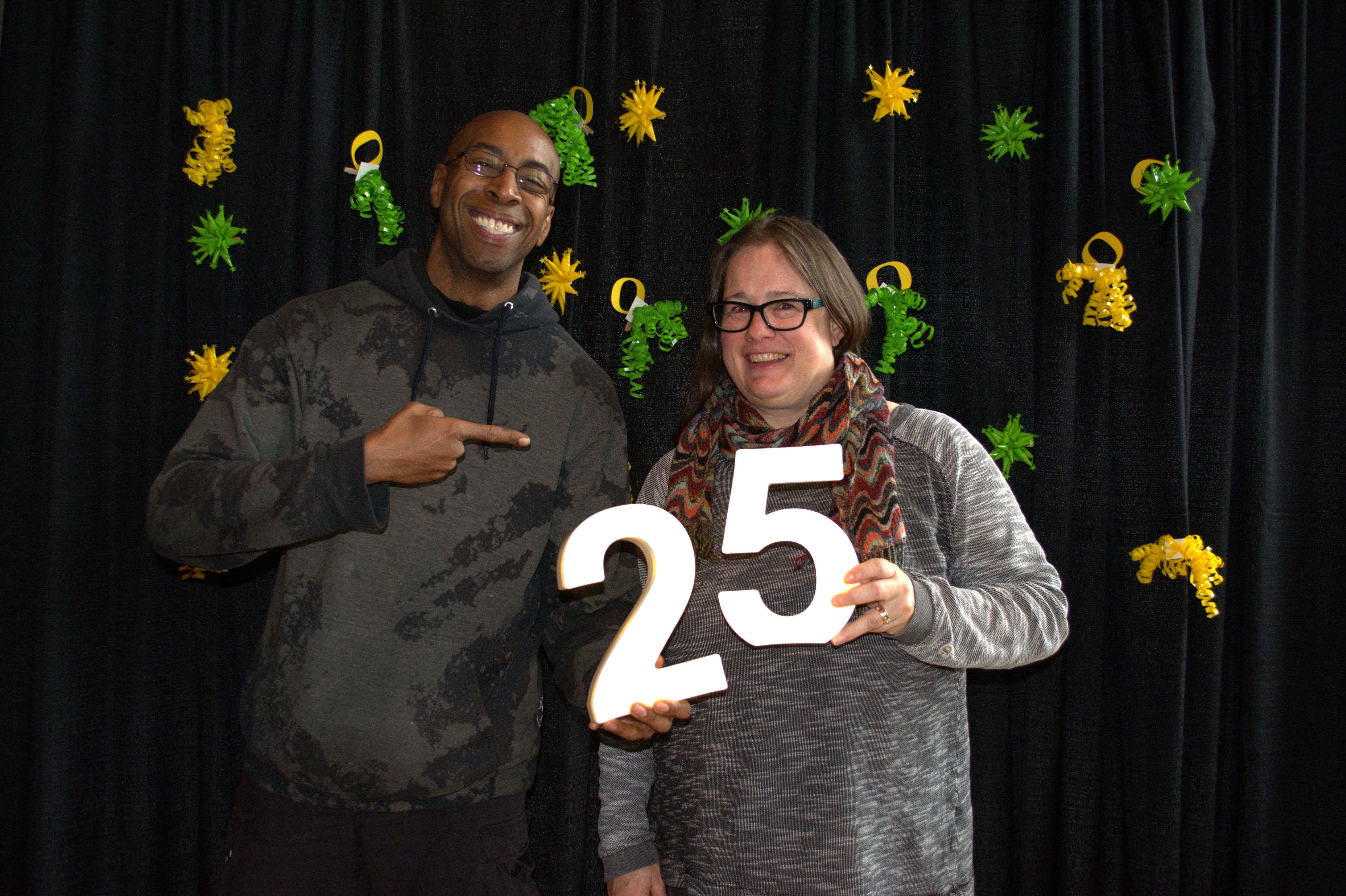 Two people celebrating someone's 25 years of service