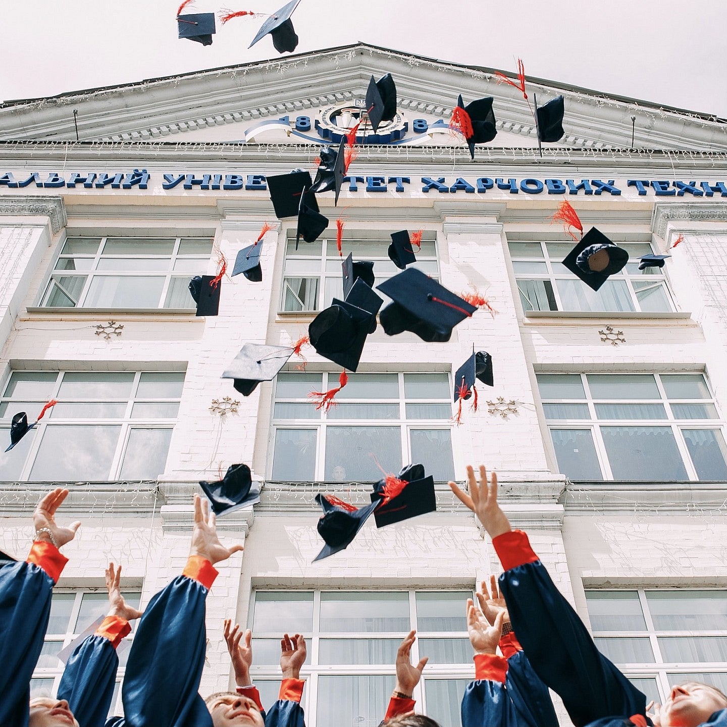 Graduation caps thrown in the air.