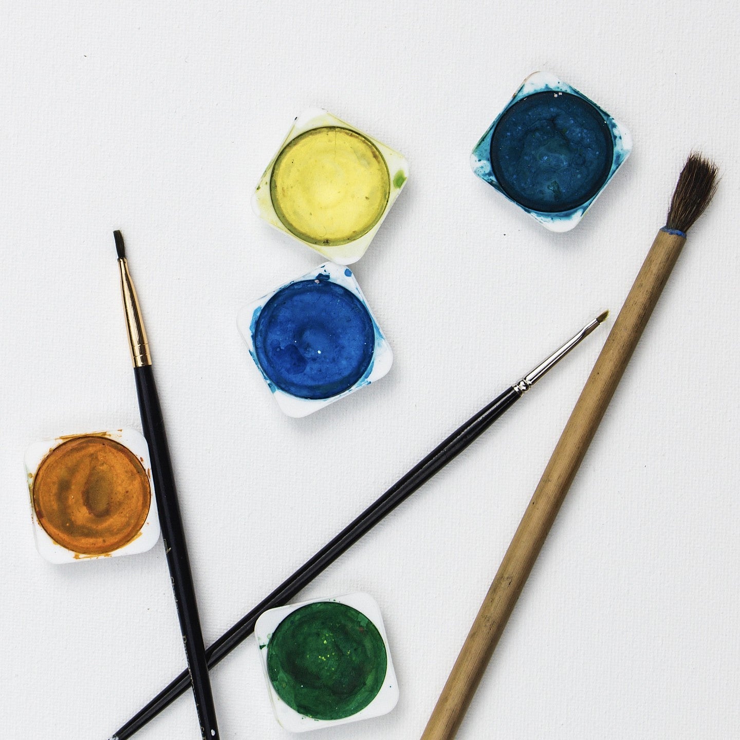 Paint brushes and pots of paint.