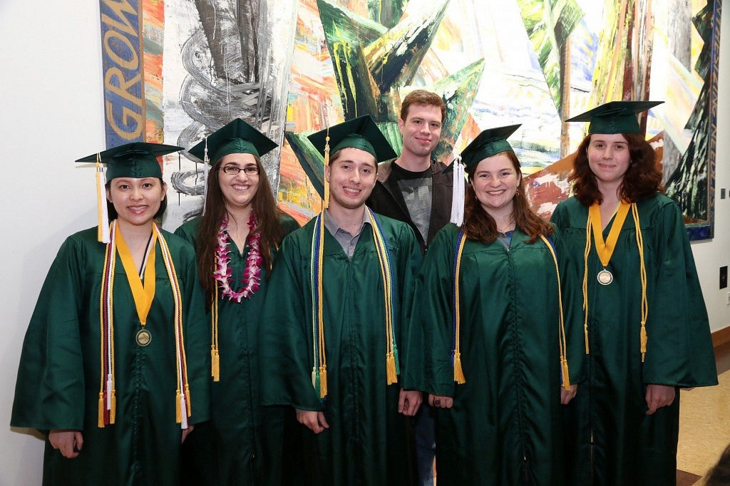2014 Oregon Six students pose together in their cap and Gowns.