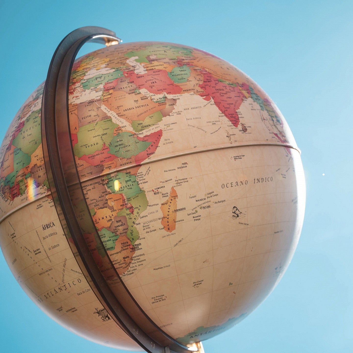 Neutral toned globe with a sky blue background.