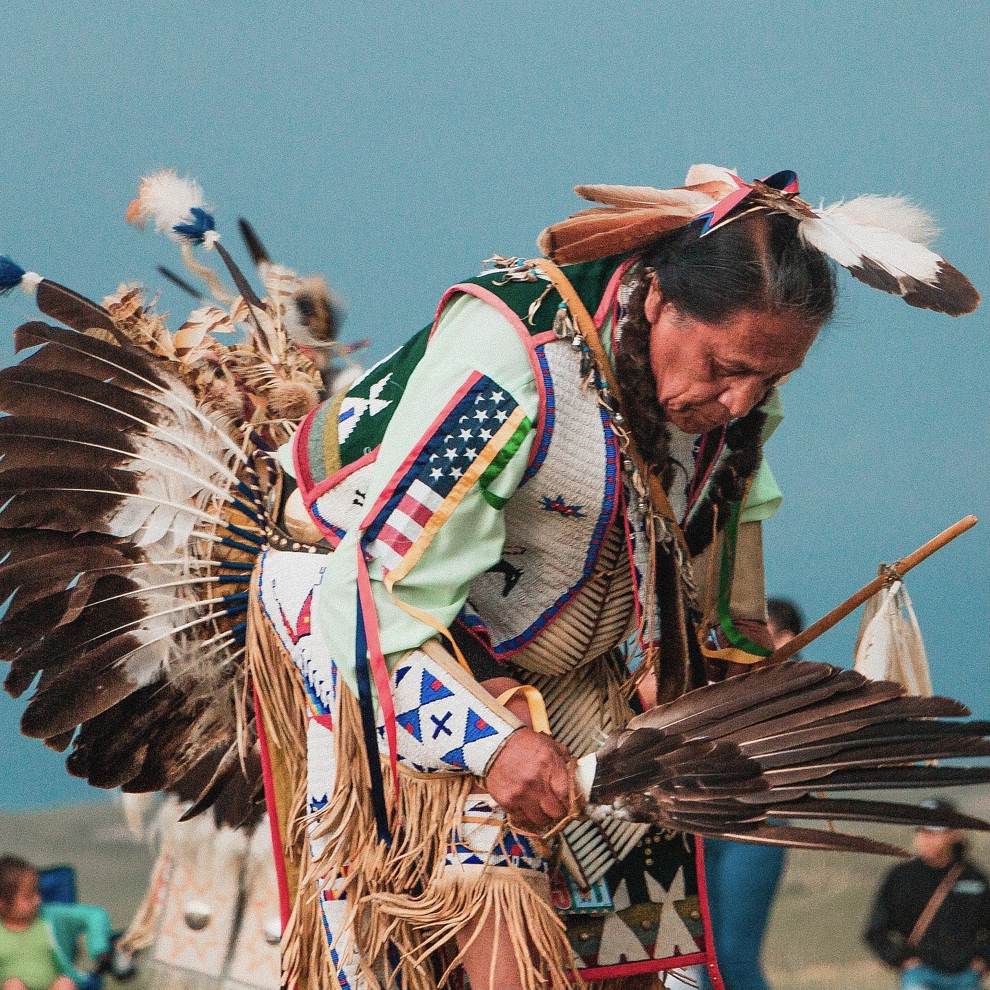 Native American elder dancing in full ceremonial garb