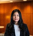 Melissa Piceno has long black hair and wears a blazer
