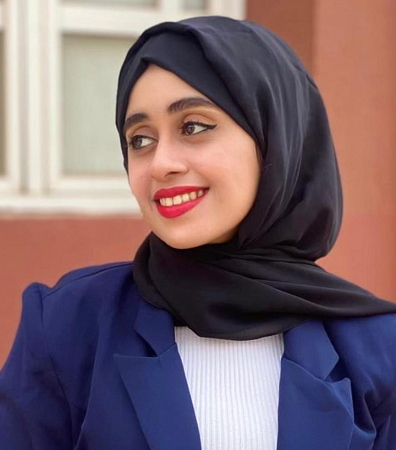 Maryam al-Ojel with head turned to the left and looking left.  She wears a traditional head covering.