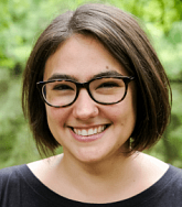 Sarah Dubrow. She has chin length dark brown hair and glasses.