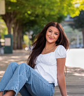 Sophia Barghouti has long brown hair and a white shirt