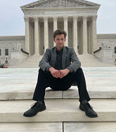 Ashton Kuhn sits on the steps of the Capitol building