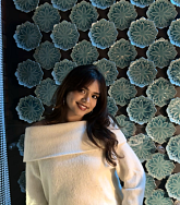 Sameeha Chowdhury has long black hair and wears a white shirt
