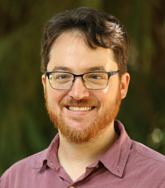 Benjamin Hutchinson has brown hair and wears glasses