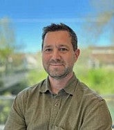Karl Reasoner has short dark hair