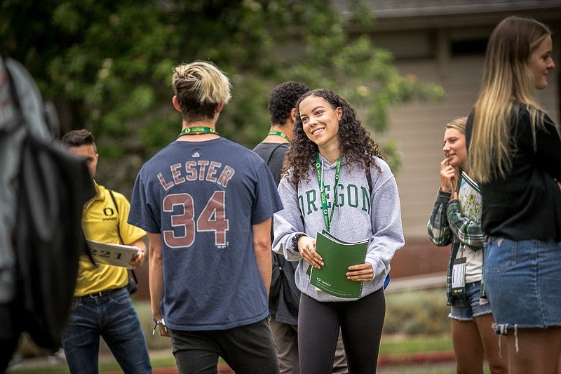students meeting and talking to one another outside during orientation