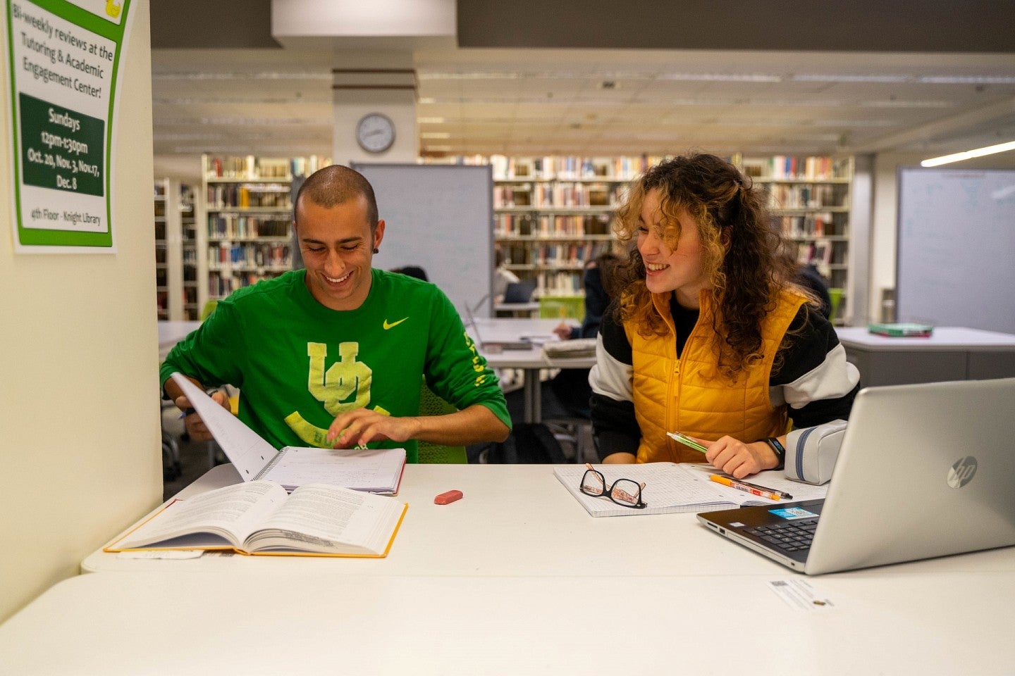 Student studies with academic advisor at Knight Library 
