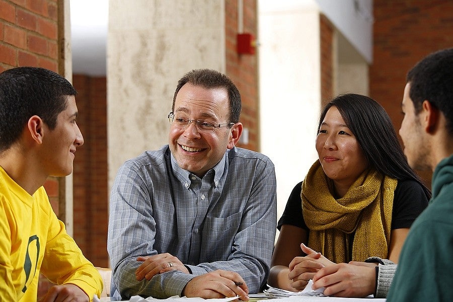Advisor meeting with a group of three