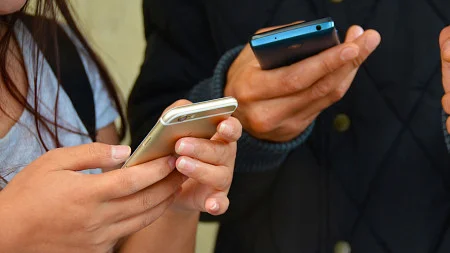 two students using phones