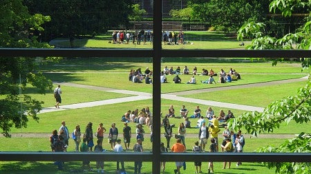  Students sitting on the lawn on the University of Oregon campus