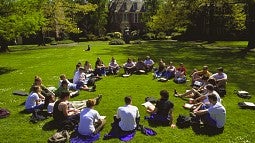  Students sitting in a circle on the lawn