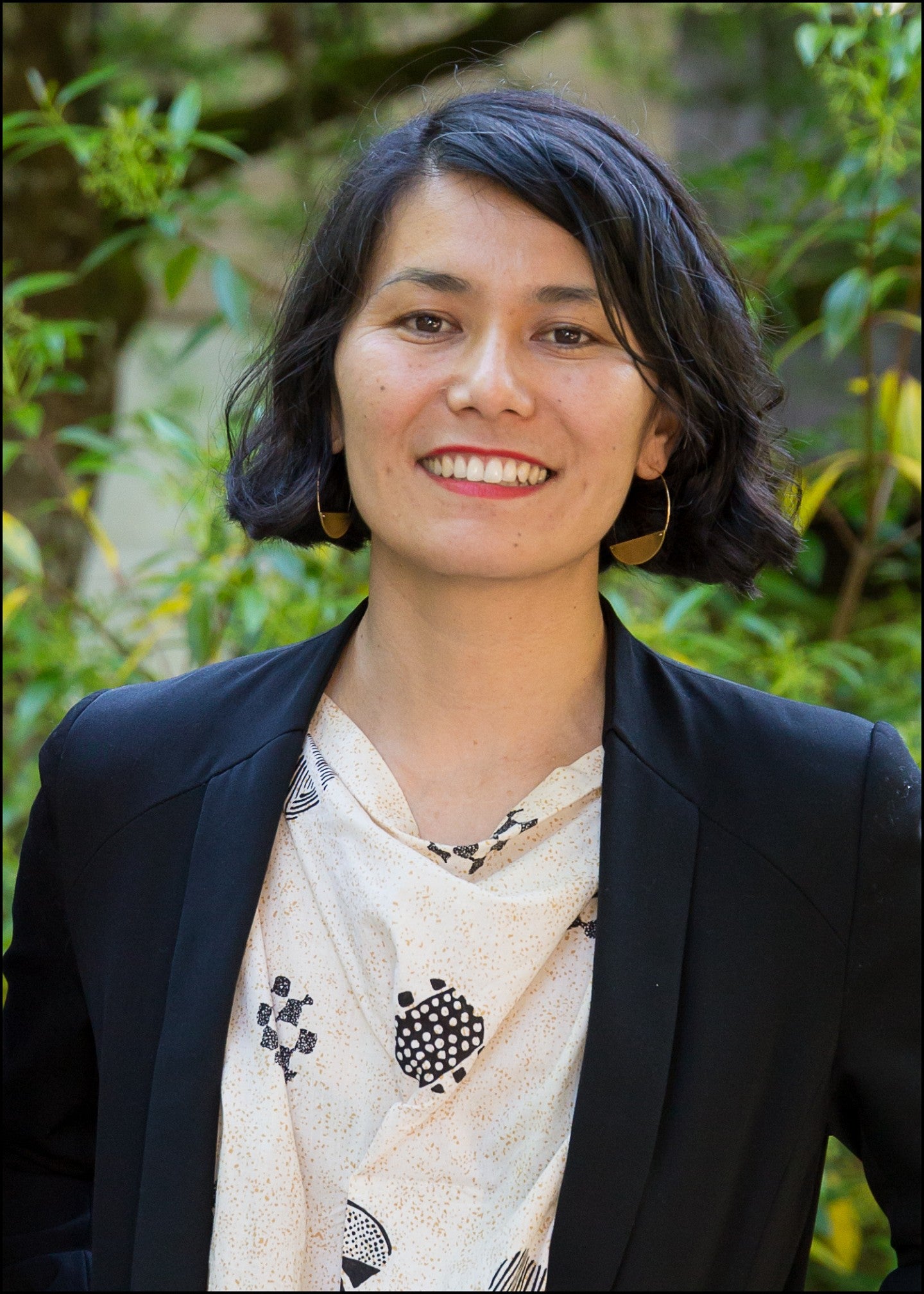 Masami Kawai headshot. Masami is smiling, has short black hair, and is wearing a white patterned shirt and black blazer.