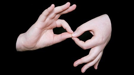 Two hands signing "interpreter" in American Sign Language