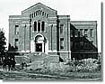 Historic photos of Gilbert Hall when with its red bricks and no trees around it
