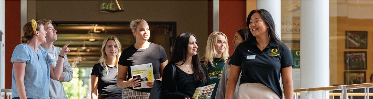 A Duck Guide leads prospective students on a tour of the Lillis Business Complex