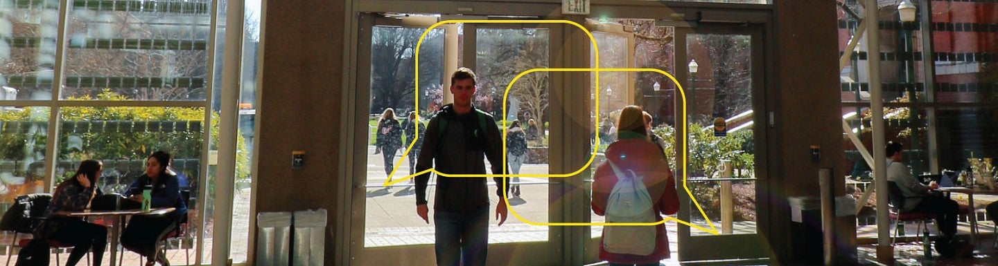Students entering and exiting the Lillis Business Complex