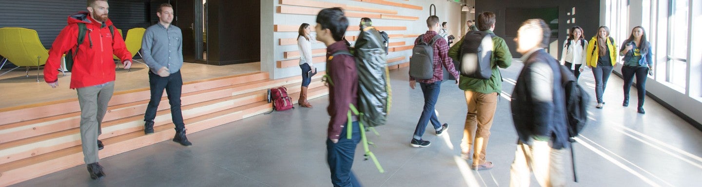 Students walking in the halls of the new Naito building