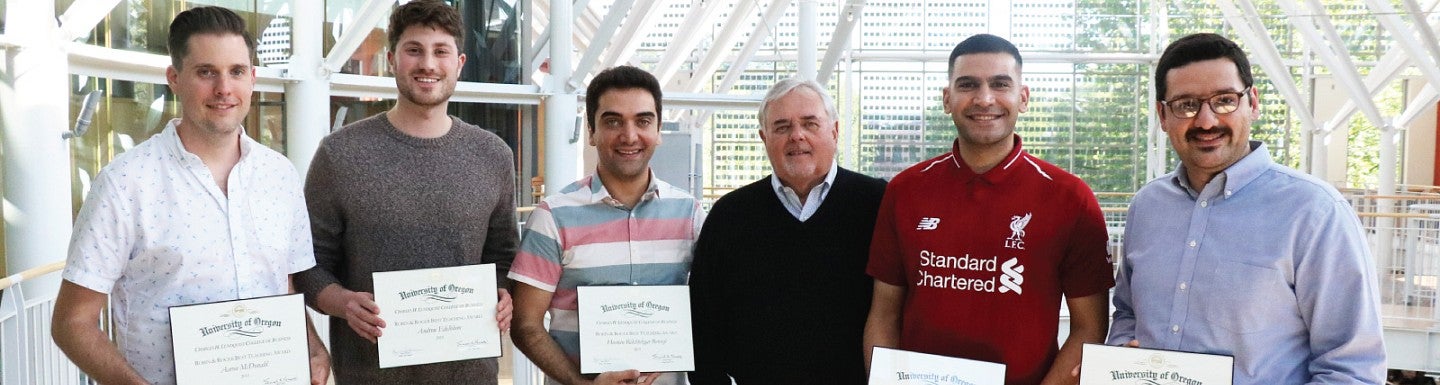 Roger Best poses for a photo with award-winning PhD students