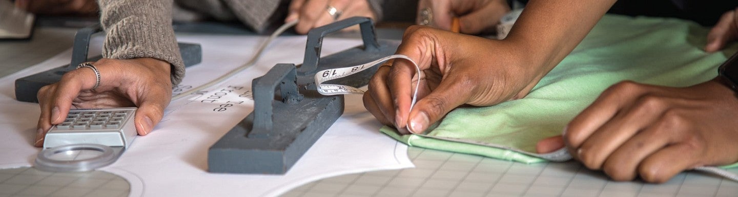 Close up photo of students working on measuring a sports product