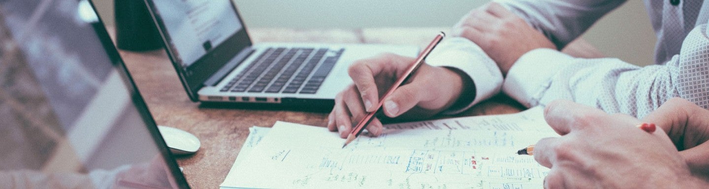 Close up photo of a person working at a laptop