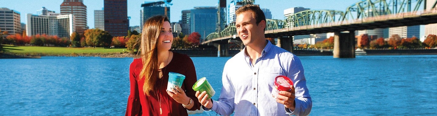 School of Accounting alumni hold their ice cream against a backdrop of Portland cityscape
