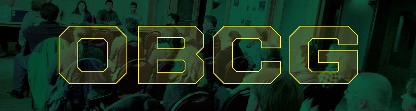 OBCG lettering in foreground of image of conference