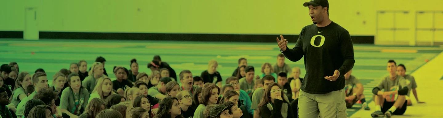 Ain instructor speaks before a group of young students
