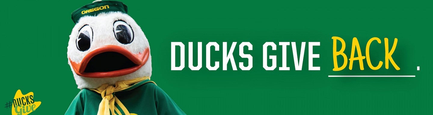 Photo of the UO Duck next to the words "Ducks Give Back"