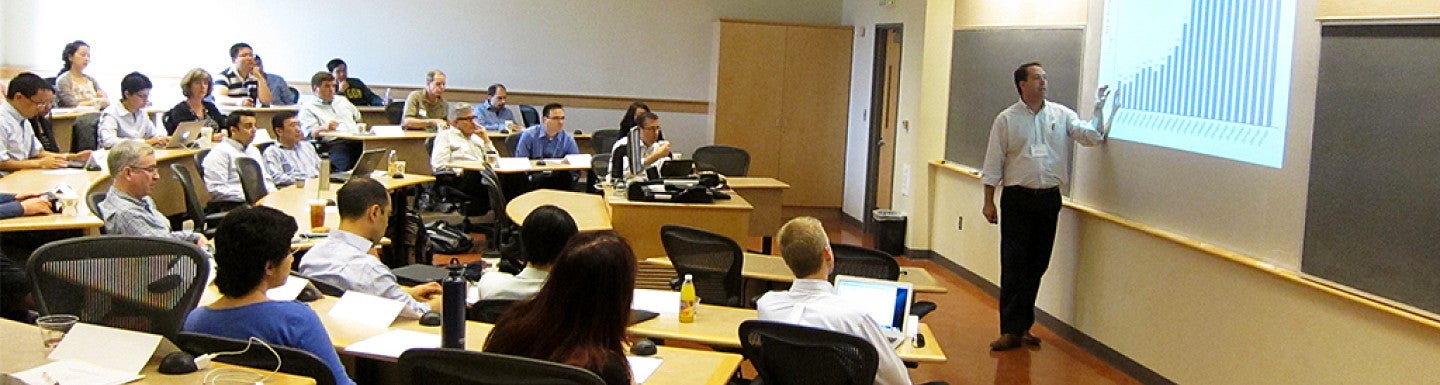 A full classroom during the conference watches the presenter