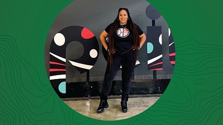 Circular photo of Erin Harville on centered on a wide green background
