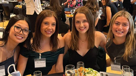 Student club members pose for a group photo while seated at a table during the 2025-2026 Dean's Council for Inter-Club Coordination End of Year Gala
