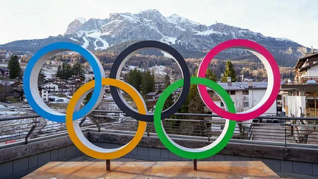 The Olympic Rings on a platform in front of the mountains in Milan, Italy for the 2026 Winter Olympic Games
