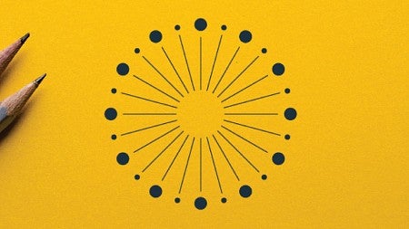 Two pencils sit on a yellow surface