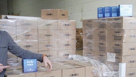 Defunkify Chief Marketing Officer Eddie Rosenberg poses beside a palette of the product