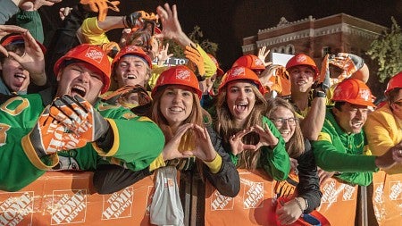 A crowd of students throw the O during College GameDay